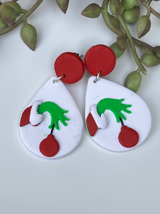 Large white Christmas earrings with iconic grinch stealing ornament image made with polymer clay & stainless steel findings