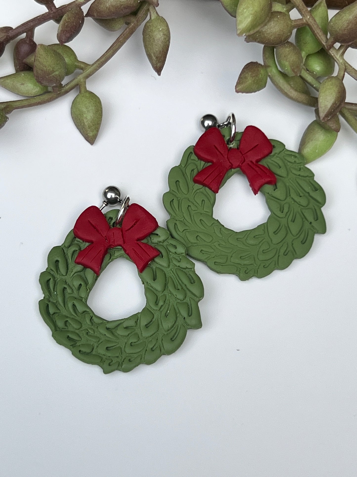 Green Christmas wreaths dangle earrings with red bow for winter holidays made from polymer clay and stainless steel findings