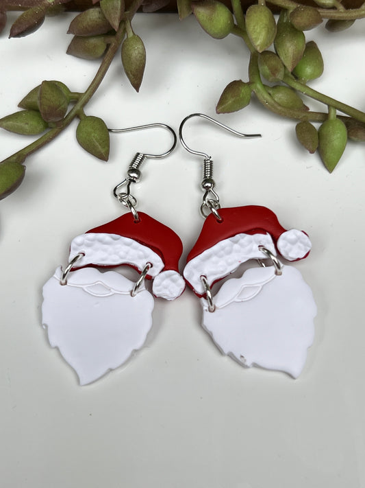 Ho! Ho! Ho! Take your Christmas spirit with you everywhere you go with these handcrafted dangles featuring the jolly one himself, the one and only Santa Claus!  Crafted with lightweight and durable polymer clay and hypoallergenic stainless steel findings.