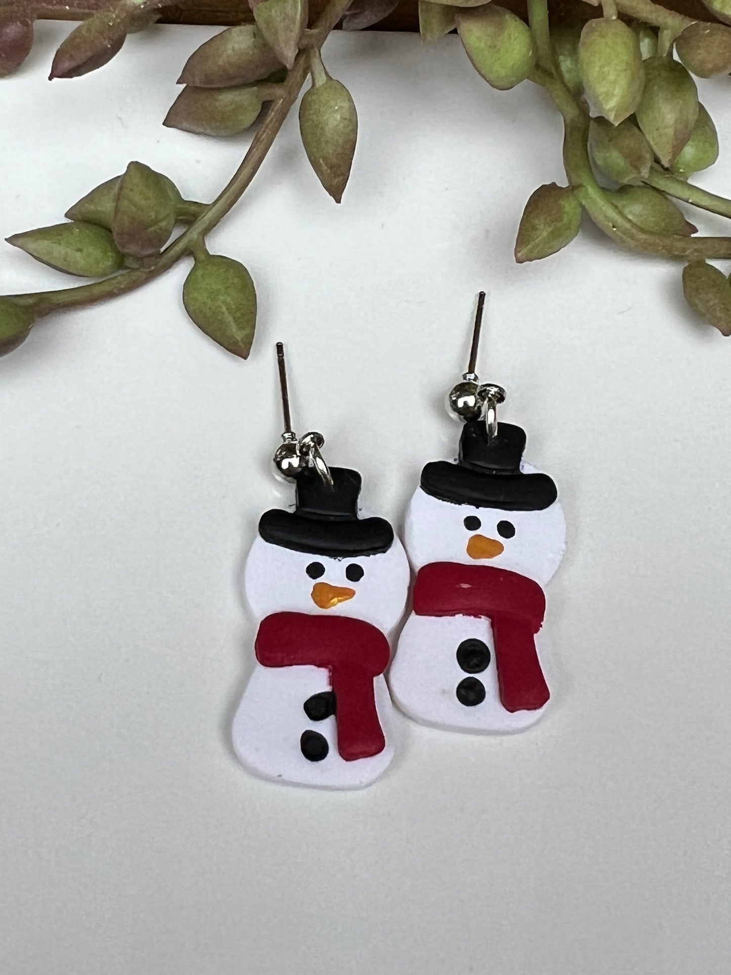 Grab a pair of these adorable, hand-painted snowman dangles before they melt away!  Crafted with lightweight and durable polymer clay and hypoallergenic stainless steel findings.