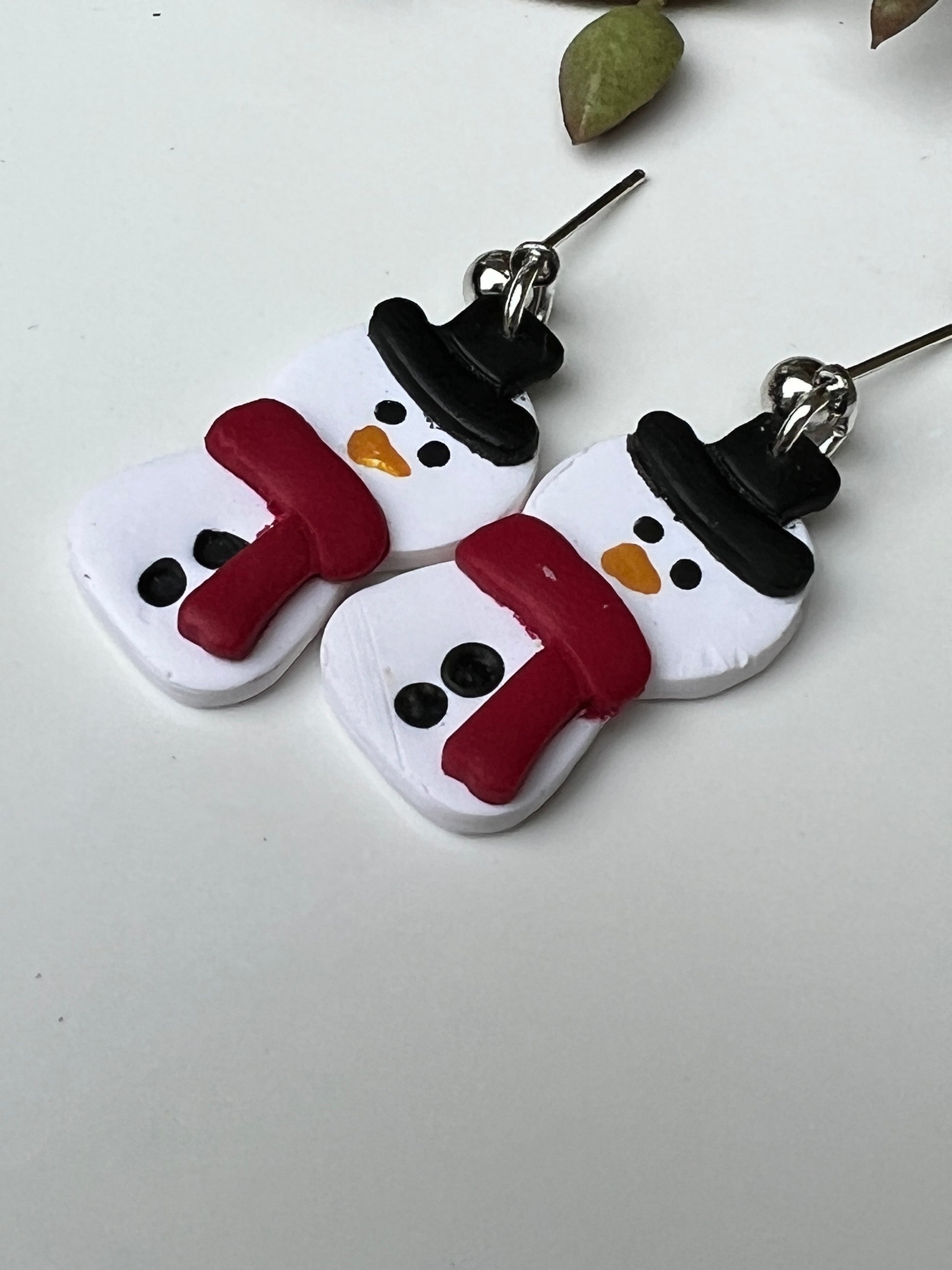 Grab a pair of these adorable, hand-painted snowman dangles before they melt away!  Crafted with lightweight and durable polymer clay and hypoallergenic stainless steel findings.